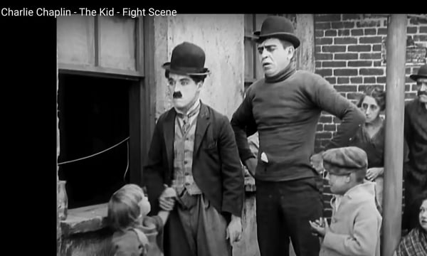 Still frame from Charlie Chaplin film, The Kid.