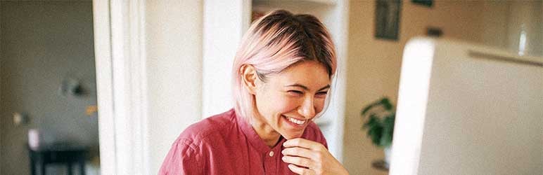 Young woman with pink hair smiling as she adds text on GIF