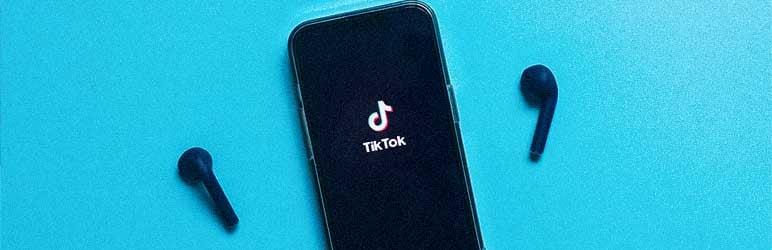 Phone with TikTok screen showing against a bright teal background with two headphones nearby
