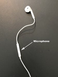 Apple wired headphone, with arrow and text pointing out the microphone part.