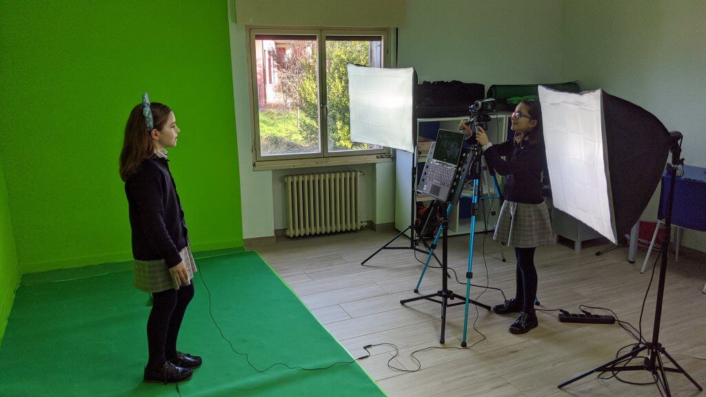 students in front of green screen