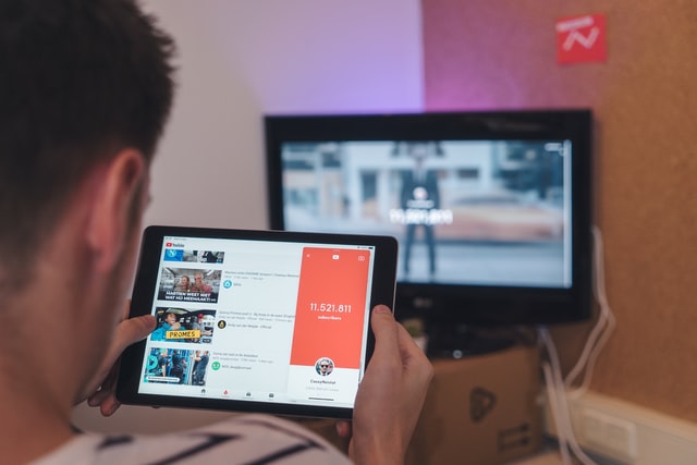 Man browsing YouTube on tablet