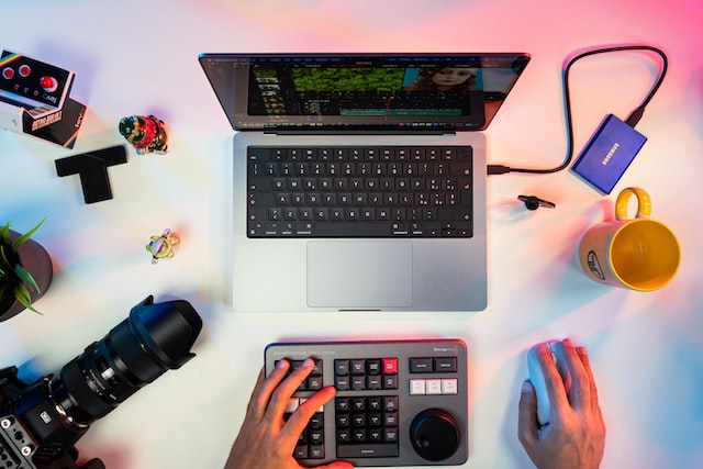 Overhead photo of filmmaker editing a film on a computer