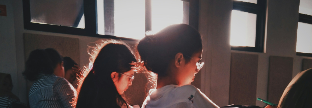 Students working with sun shining in through a window.