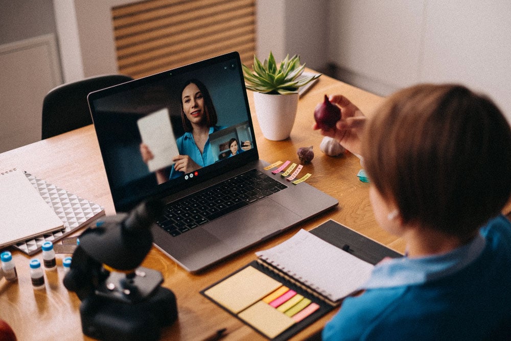 Young student receives feedback from teacher over video call.jpg