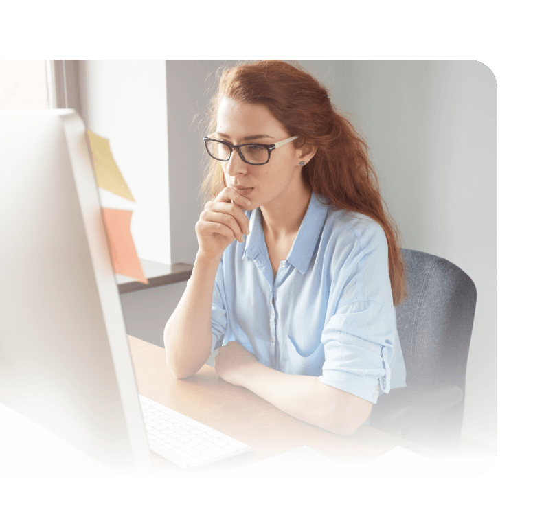 Young businesswoman studying computer screen. 