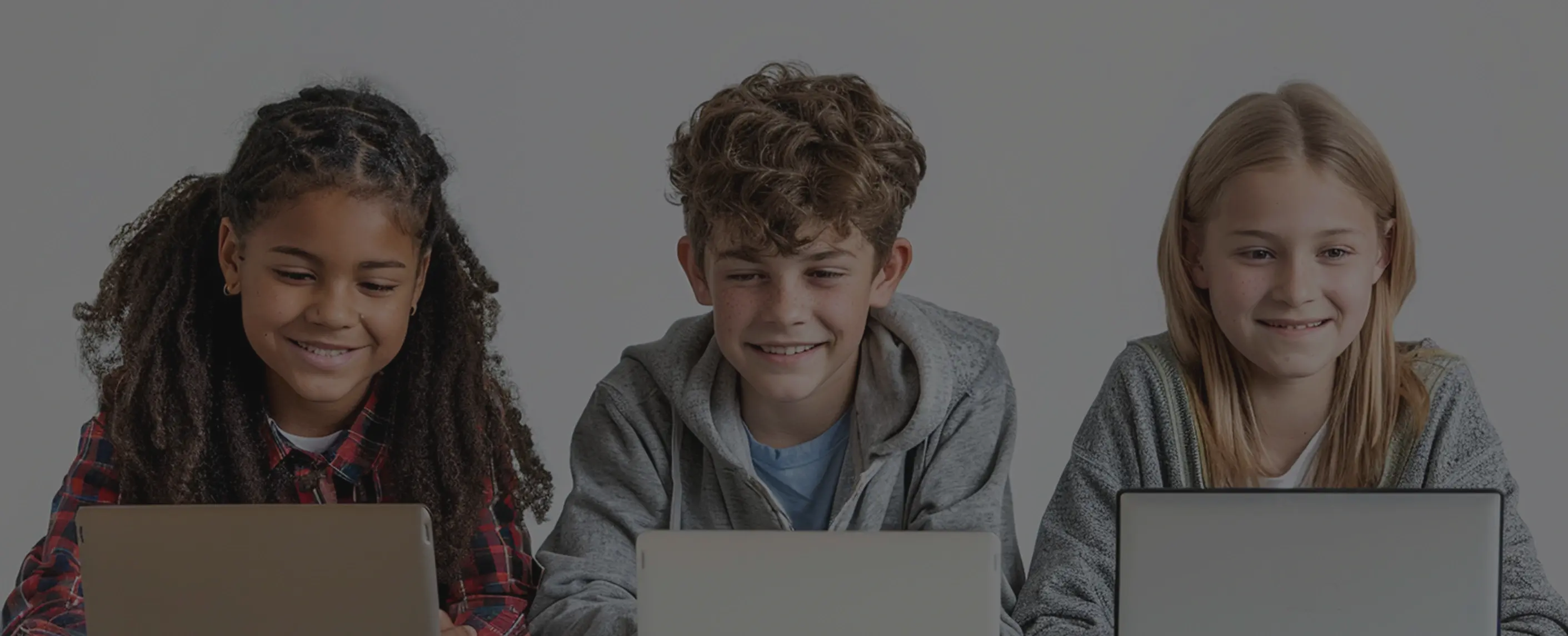 Kids focused on laptops