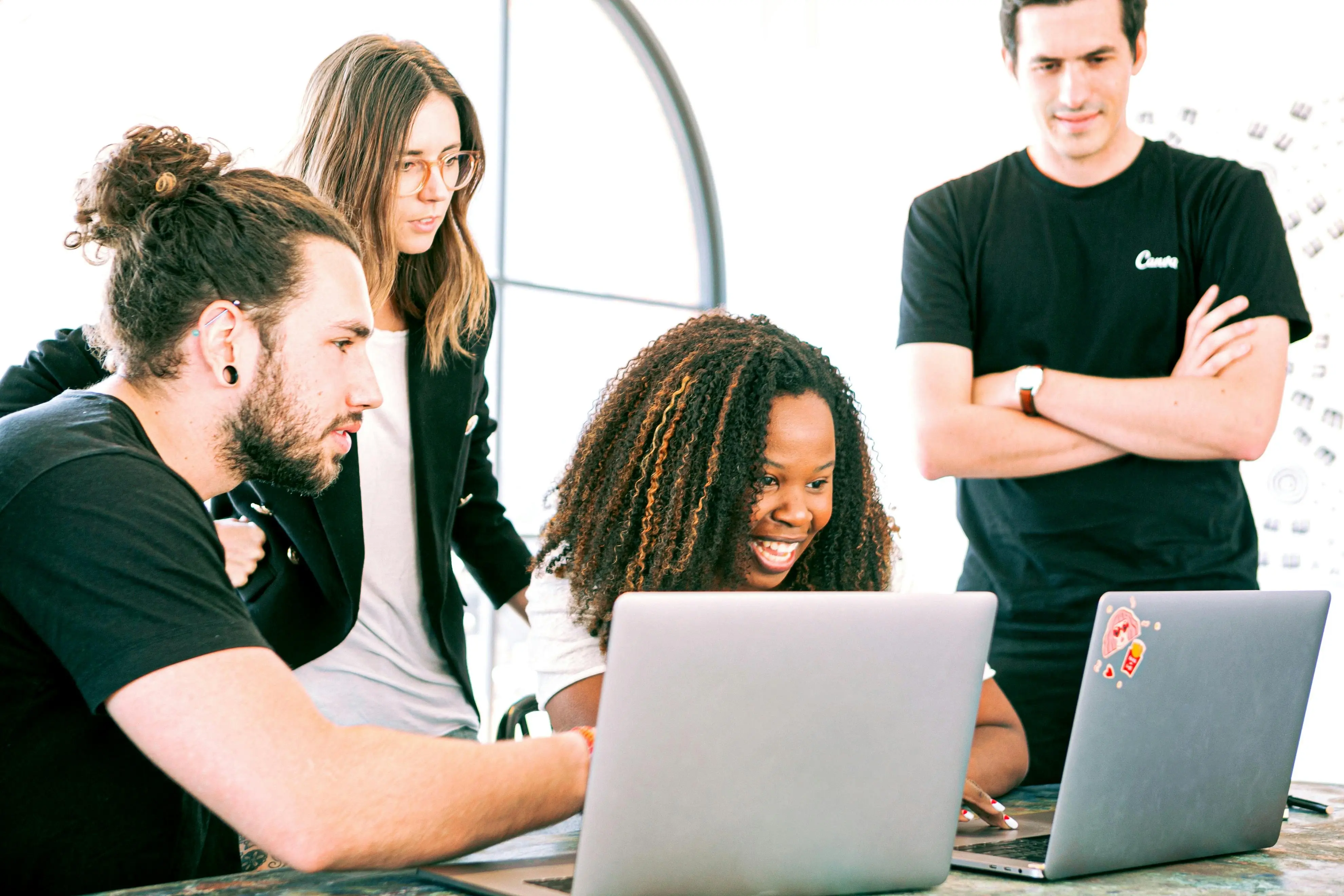 Team working together on two laptop computers.