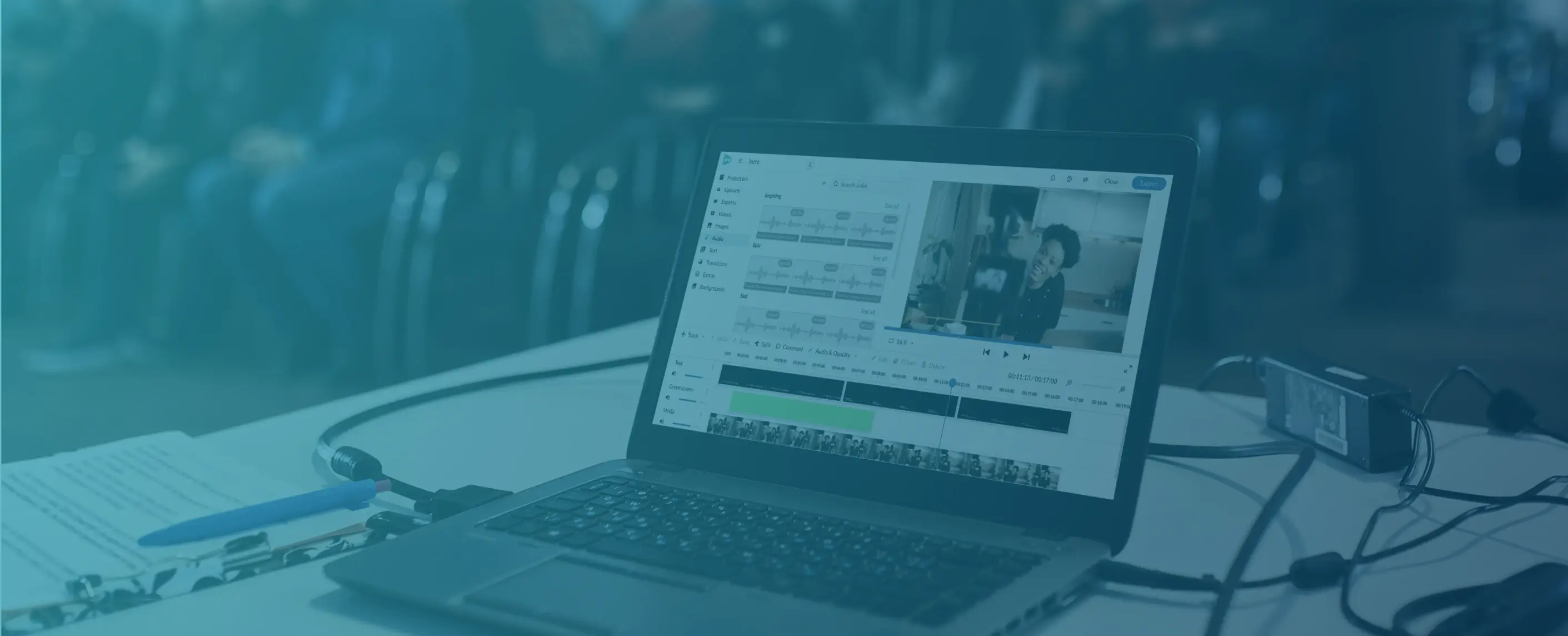 Teal background with laptop with a video editor open.