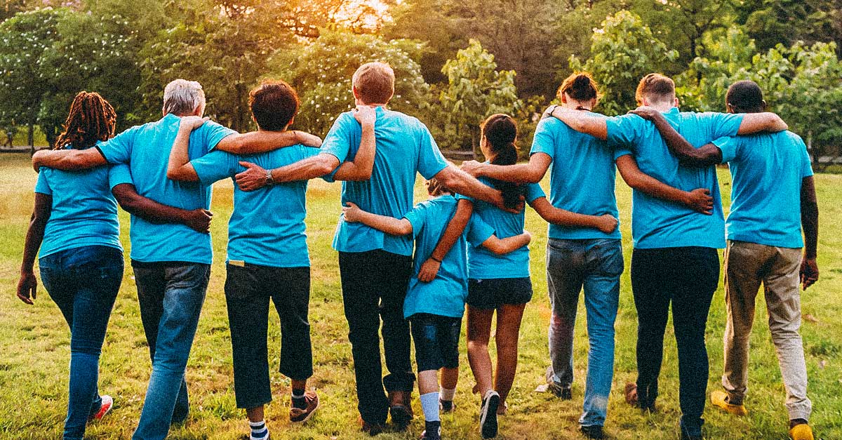 Nonprofit group with their backs toward camera and arms around each other