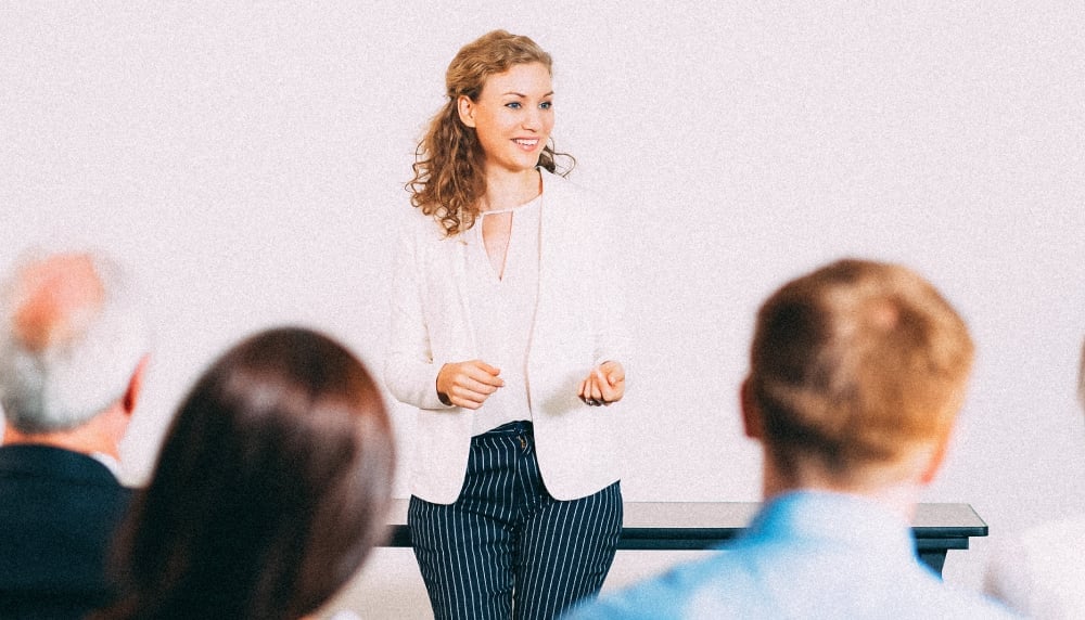 Woman giving a presentation to a group of people.