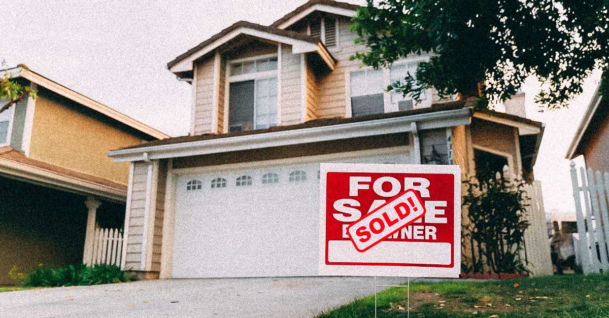 Home with a red Sold! sign out front