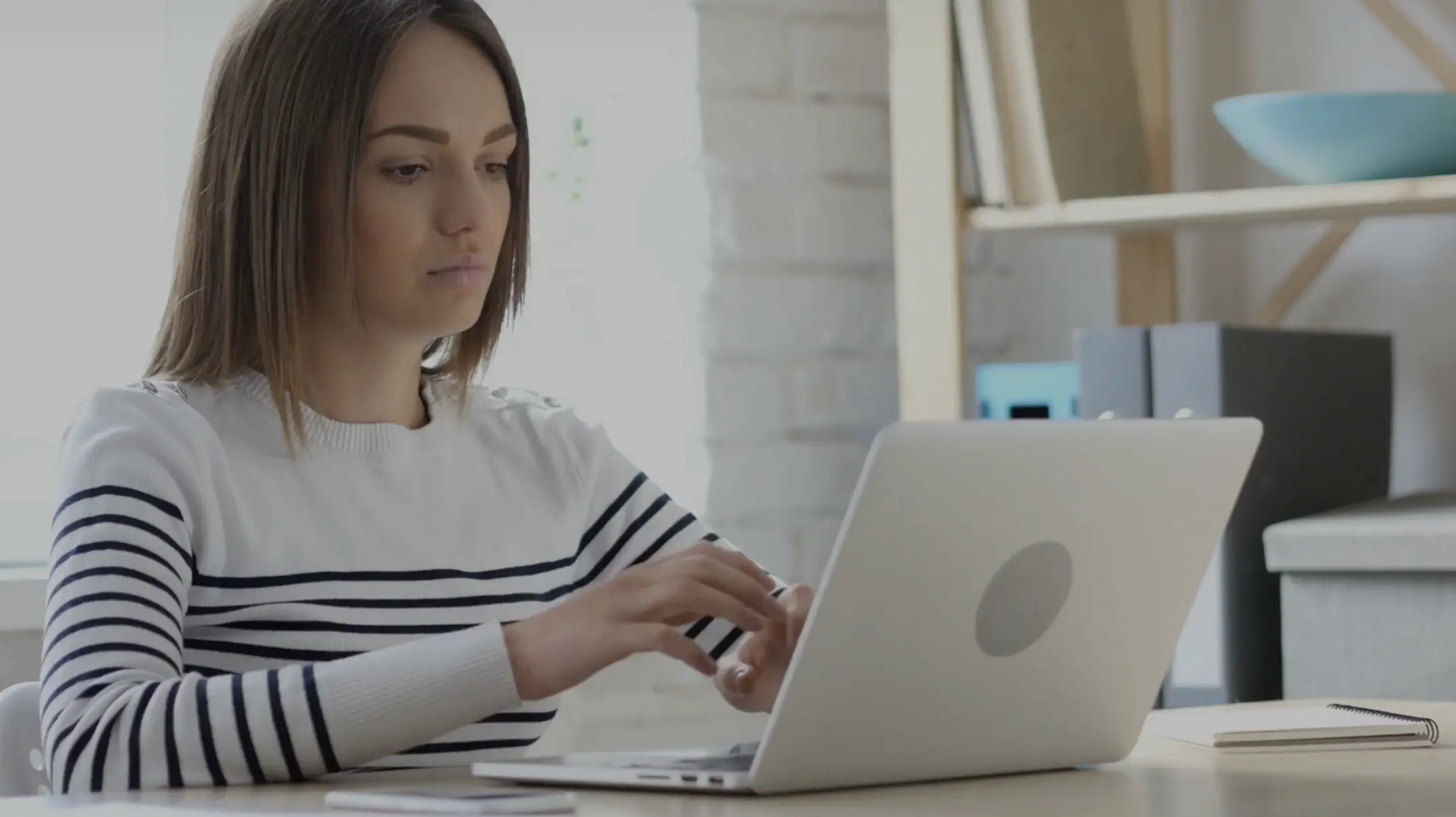 Adult female working on laptop.