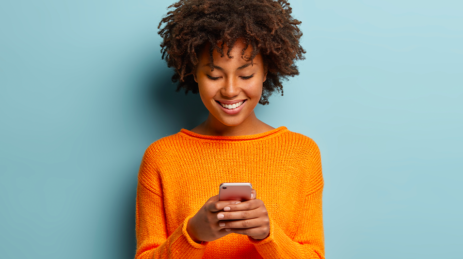 Woman standing against light blue background watching video meme