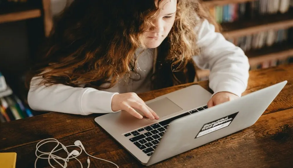 Young learner in front of a computer concentrating on a project