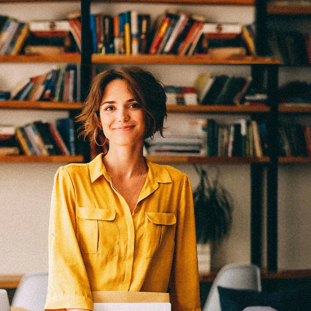Smiling business woman in her office wearing a yellow shirt