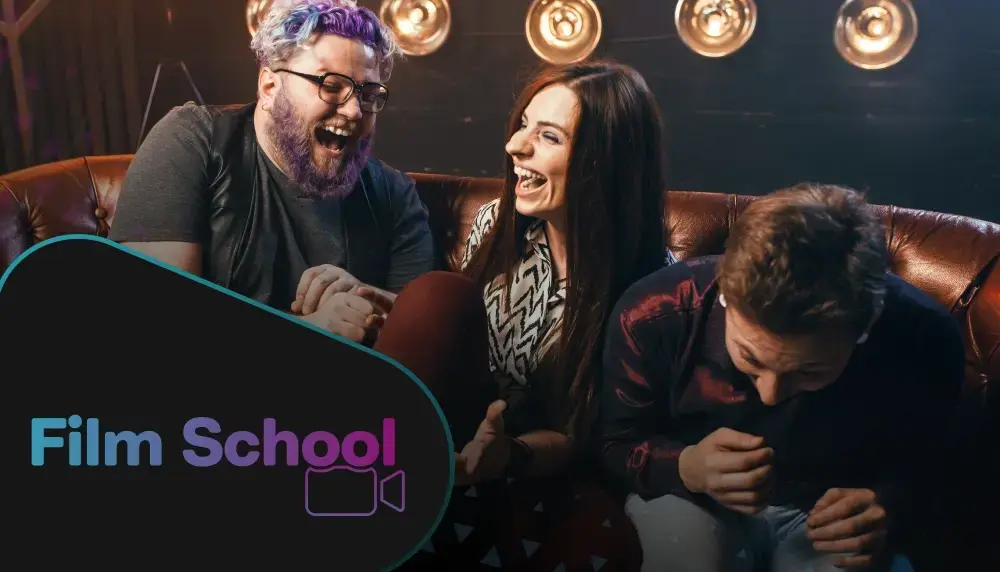 A group of three laughing together watching a comedy film in a theater with WeVideo's 