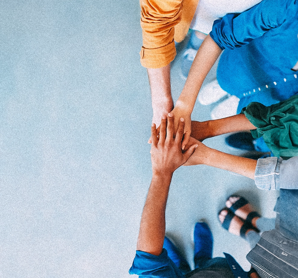 Hands meeting together in center, one on top of another.